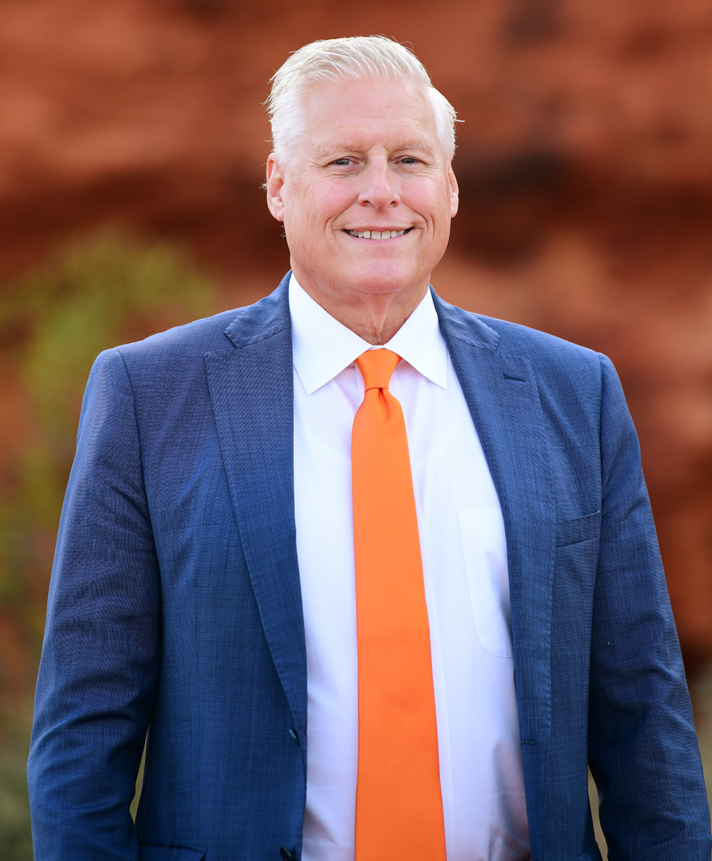 Portrait of Todd Renda, Utah SSD attorney at Barnes Disability Advocates, in front of red rocks.