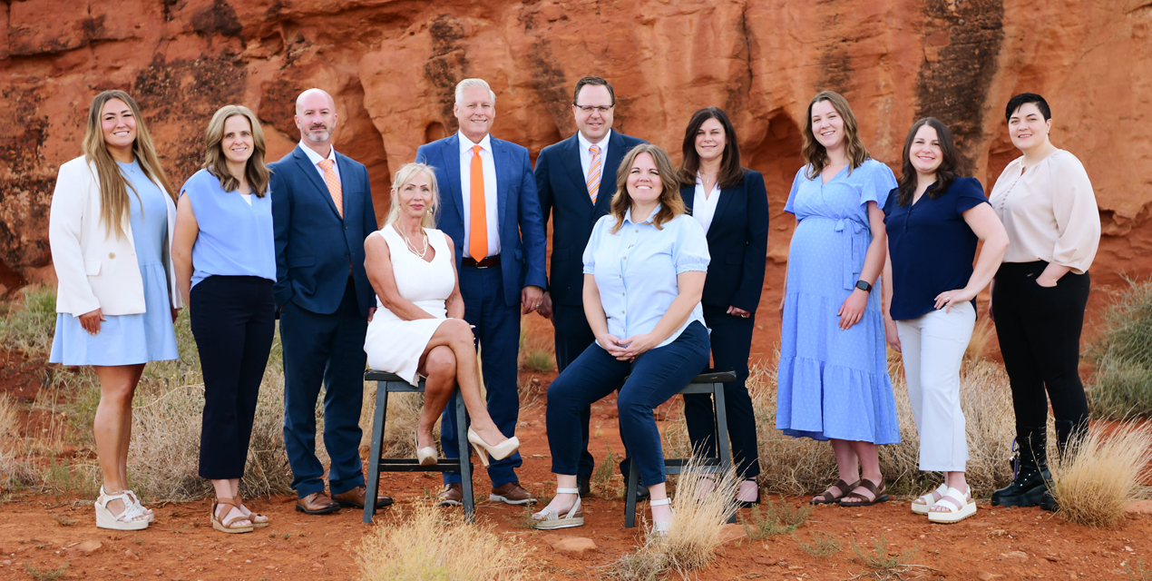 The SSD lawyers and team at Barnes Disability Advocates, 11 people, in a group photo in front of red rocks in Utah.